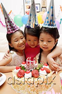 AsiaPix - Three girls celebrating a birthday, looking at cake