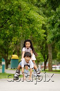 AsiaPix - Children rollerblading, boy falling down