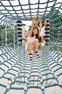 AsiaPix - Girls going through net tunnel in playground