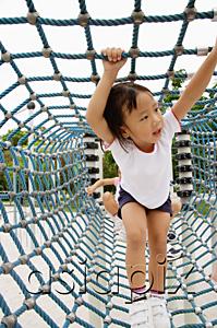 AsiaPix - Young girl going through net tunnel in playground, other girls behind her