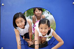 AsiaPix - Girls in playground, climbing through a hole