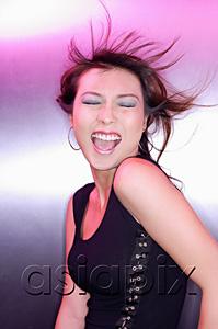 AsiaPix - Woman with eyes closed, mouth open, with wind blown hair