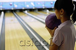 AsiaPix - Woman preparing to bowl, over the shoulder view