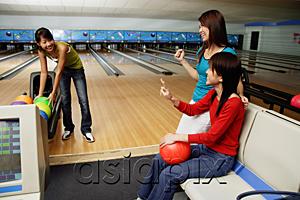 AsiaPix - Women in bowling alley, one choosing ball