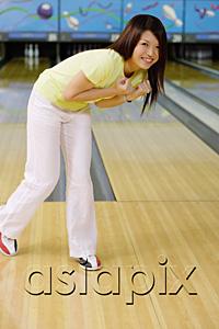 AsiaPix - Woman at bowling alley, bending over smiling