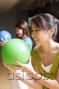 AsiaPix - Two women with bowling balls, preparing to bowl