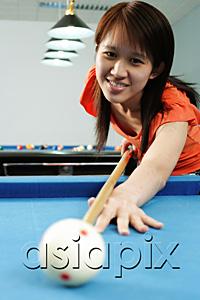 AsiaPix - Woman in orange top, holding pool cue, aiming at ball