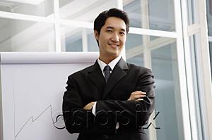 AsiaPix - Businessman looking at camera, arms crossed, smiling