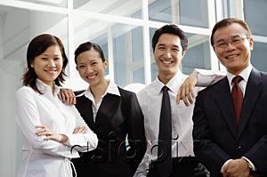 AsiaPix - Business people standing side by side, smiling at camera