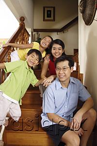 AsiaPix - Family with two children, sitting on stairs, smiling at camera