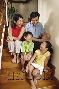AsiaPix - Family sitting on stairs, looking at each other