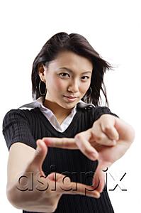 AsiaPix - Young woman making hand sign