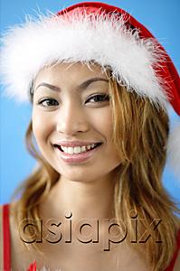 AsiaPix - Woman wearing Santa hat, smiling at camera