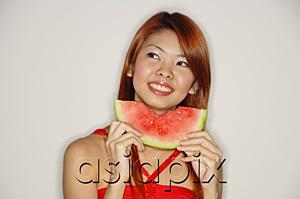 AsiaPix - Woman with a slice of watermelon, smiling