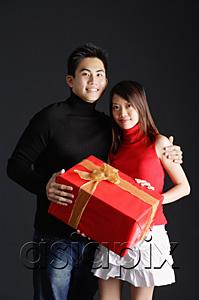 AsiaPix - Couple standing side by side, holding gift