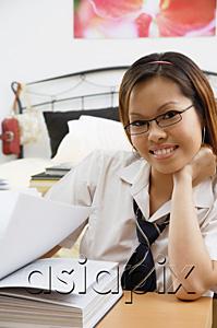 AsiaPix - Girl in school uniform, book open in front of her, smiling at camera