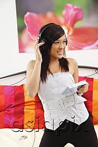 AsiaPix - Girl in bedroom, listening to headphones