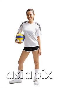 AsiaPix - Young woman standing and holding volleyball