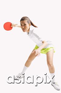 AsiaPix - Young woman playing table tennis, studio shot