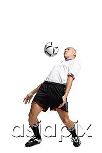 AsiaPix - Young man in soccer uniform, hitting ball with his chest