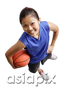 AsiaPix - Young woman holding basketball, smiling at camera