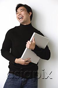 AsiaPix - Man hugging laptop, laughing