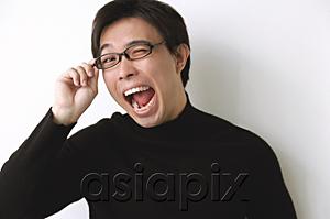 AsiaPix - Man in black turtleneck, adjusting glasses, mouth open