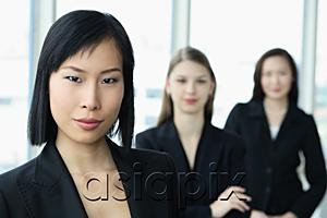AsiaPix - Businesswoman looking at camera, other women behind her