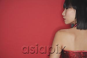 AsiaPix - Woman against red background, rear view