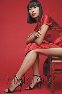 AsiaPix - Woman wearing cheongsam and high heels, sitting on chair