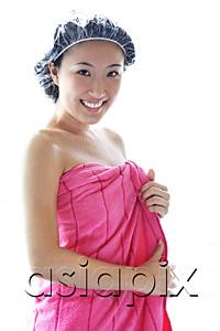 AsiaPix - Young woman wearing shower cap and towel, smiling at camera