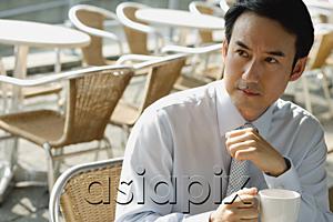 AsiaPix - Businessman in cafe holding mug
