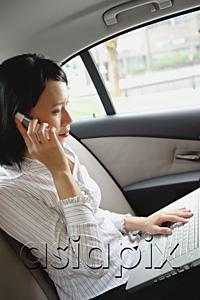 AsiaPix - Businesswoman in car on the phone and using laptop