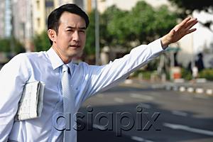 AsiaPix - Businessman flagging a cab