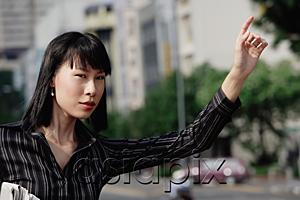 AsiaPix - Businesswoman flagging a cab