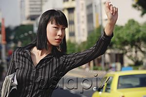 AsiaPix - Businesswoman hailing a taxi