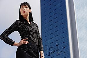 AsiaPix - Businesswoman with hand on hip, portrait