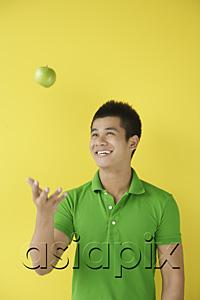 AsiaPix - Man tossing green apple