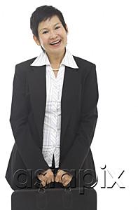 AsiaPix - Businesswoman with briefcase, smiling at camera
