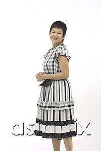 AsiaPix - Mature woman against white background, smiling at camera