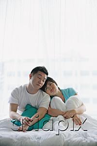 AsiaPix - Couple sitting on bed, eyes closed
