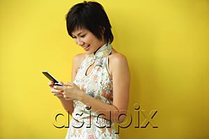 AsiaPix - Woman using mobile phone, text messaging