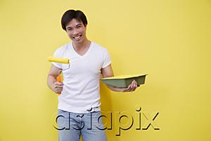 AsiaPix - Man holding paint roller and paint tray