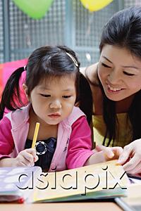 AsiaPix - Mother with young daughter, looking through book