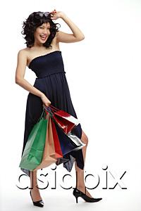 AsiaPix - Woman in black dress, carrying shopping bags, smiling at camera