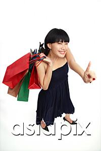 AsiaPix - Young woman carrying shopping bags, pointing finger