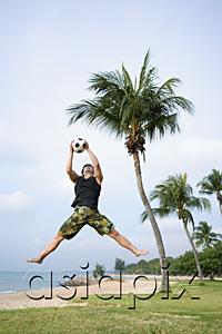 AsiaPix - Man jumping in air to catch soccer ball