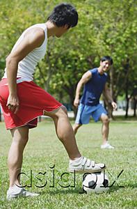 AsiaPix - Two men playing soccer in park