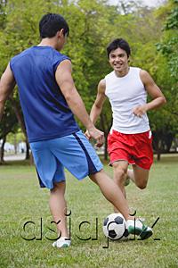 AsiaPix - Two men in park, playing soccer
