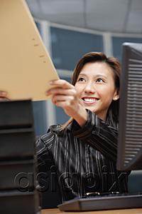 AsiaPix - Female executive handing folder to someone in front of her